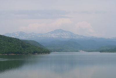 Scenic view of lake and mountains against sky