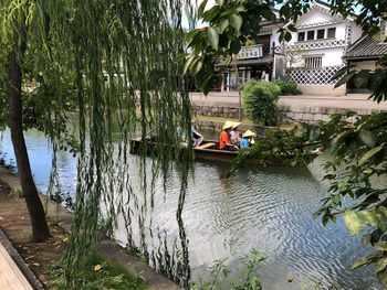 People on lake against trees