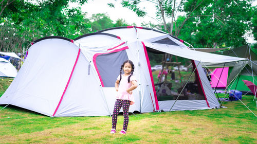 Tent in traditional clothing standing on field