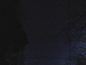 Low angle view of moon in the dark