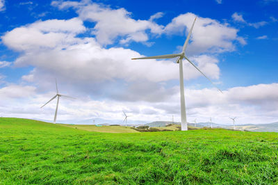 Windmill on field against sky