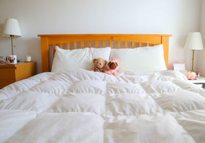 Stuffed toys on bed at home