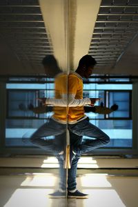 Rear view of men standing on glass floor