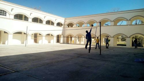 Rear view of a woman in front of historical building