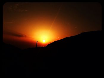 Scenic view of sunset over mountains