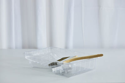 High angle view of glasses on table against white background