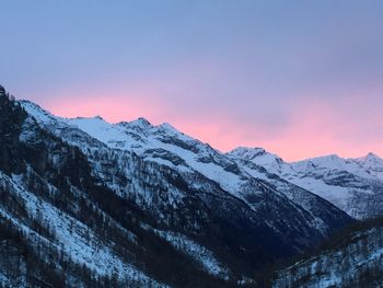 Scenic view of snowcapped mountains against sky during sunset