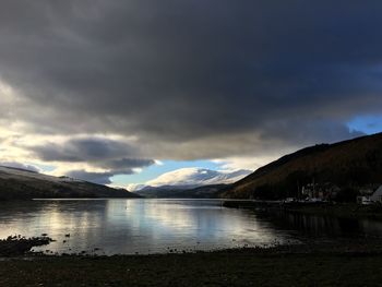 Scenic view of lake and mountains against sky