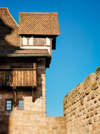 Low angle view of building against clear blue sky
