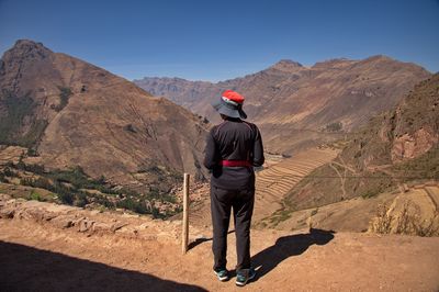 Rear view of man walking on mountain