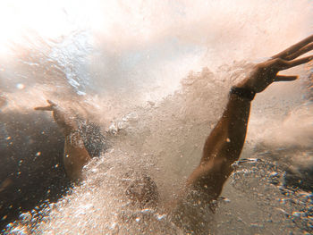 Close-up of man hand diving underwater