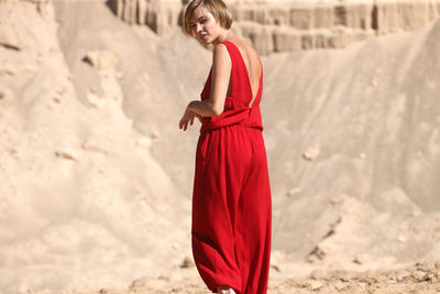 Side view of a smiling woman standing on land