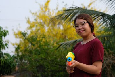 Portrait of beautiful young woman standing outdoors