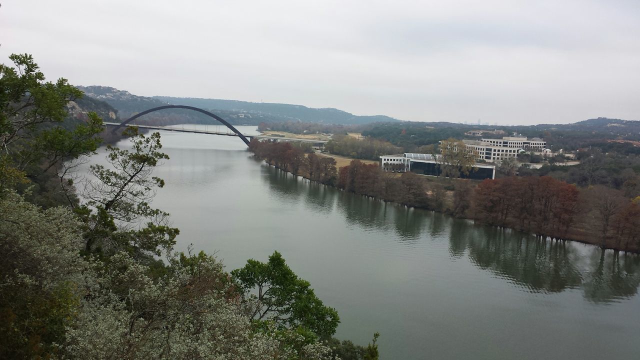 architecture, built structure, water, tree, building exterior, mountain, river, reflection, sky, house, bridge - man made structure, lake, waterfront, connection, canal, nature, tranquility, residential structure, day, tranquil scene