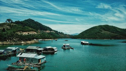 Boats moored in lake against sky