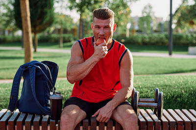 Portrait of young man drinking beer