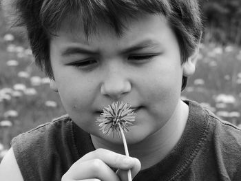 Close-up of boy holding flower