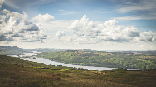 Scenic view of river and mountains against sky