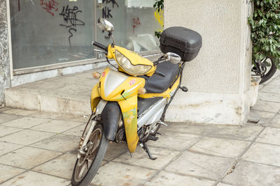 Bicycle parked on footpath by street