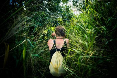 Rear view of woman standing on field