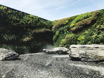Scenic view of waterfall against sky