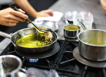 Midsection of man preparing food in kitchen