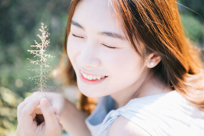 Close-up portrait of smiling young woman