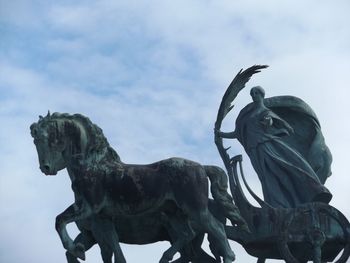 Low angle view of statue against cloudy sky