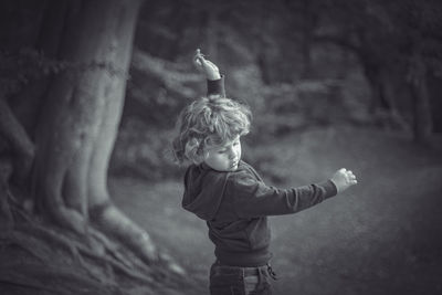 Boy dancing in the woods