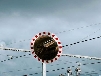 Low angle view of telephone pole against sky