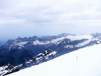 Scenic view of snow covered mountains against sky
