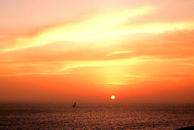 Scenic view of sea against orange sky