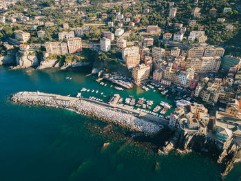 Italian riviera from above - liguria coast, camogli city fishing boat harbor and ancient old town. 