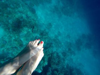 Low section of woman in sea