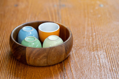 High angle view of tea cups on wooden table