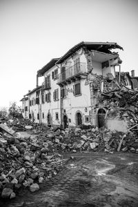 Abandoned buildings in city against clear sky