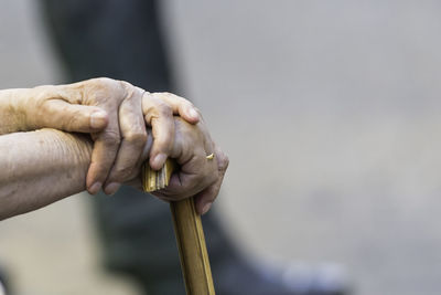 Close-up of senior person holding walking cane