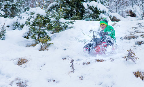 Portrait of boy playing in snow