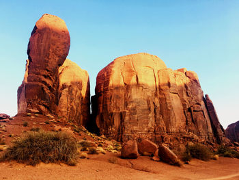 Rock formations on landscape against clear sky