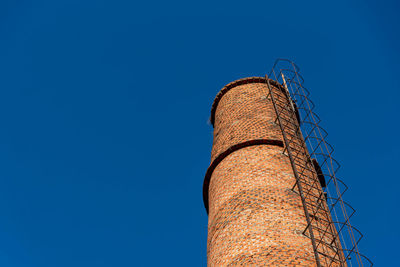 Low angle view of tower against clear blue sky