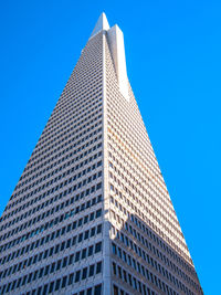 Low angle view of modern building against clear blue sky