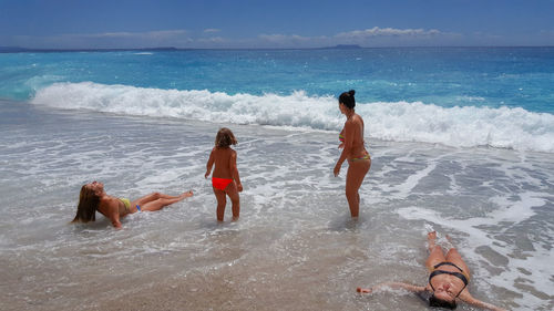 People on beach against sky