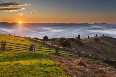 Scenic view of field against sky during sunset