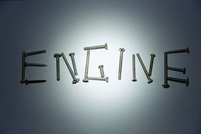 Engine text made by screws on white background