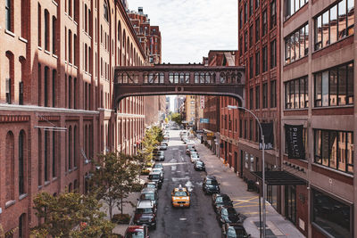 High angle view of vehicles on road amidst buildings in city