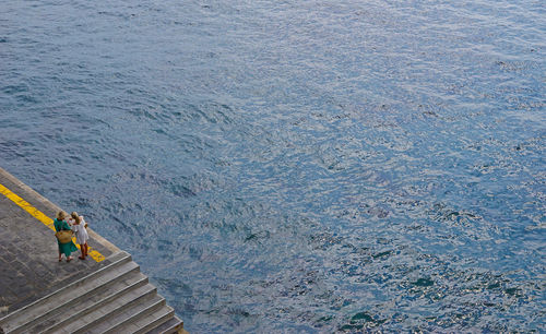 High angle view of women standing against sea