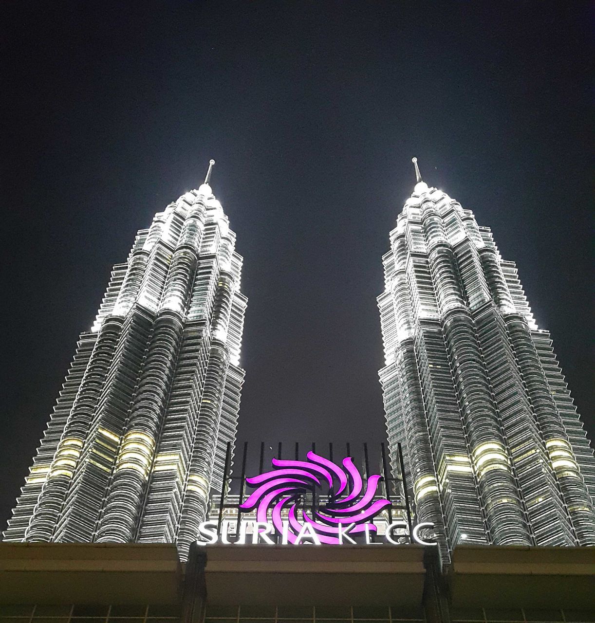 LOW ANGLE VIEW OF ILLUMINATED BUILDING AGAINST SKY