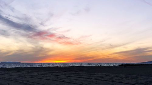 Scenic view of beach against sky during sunset