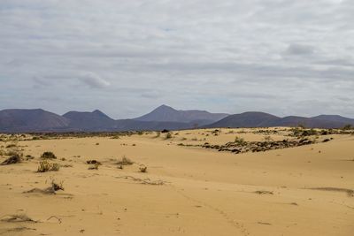 Scenic view of mountains against cloudy sky
