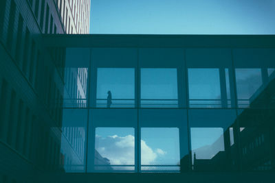 Reflection of silhouette man on glass window